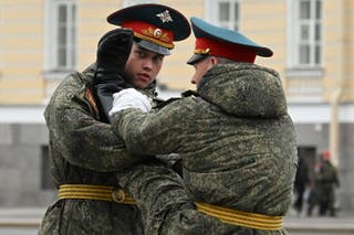 Russian honour guards soldiers get ready for a rehearsal for the Victory Day military parade at Dvortsovaya Palace Square in Saint Petersburg
